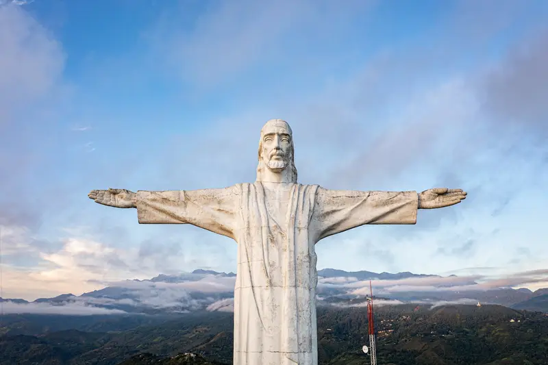 Cristo Rey statue overlooking Cali under a blue sky