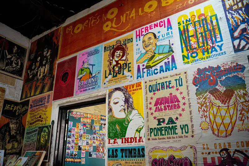 Wall of screen-printed posters in a Cali workshop